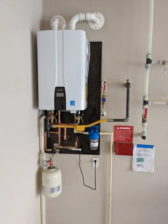 Professional plumber installing copper piping in a Metter home